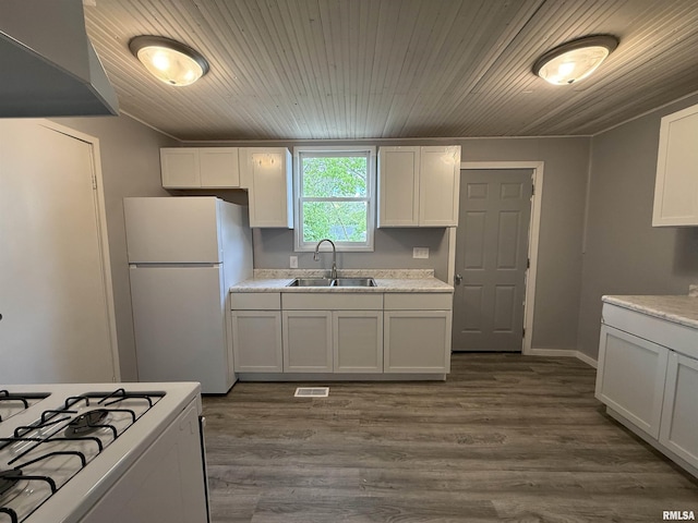 kitchen with white appliances, a sink, wooden ceiling, light countertops, and dark wood-type flooring