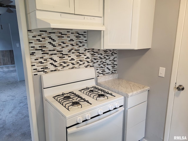 148 Robinson Ct, Canton, IL 61520 - kitchen with white gas range, exhaust hood, tasteful backsplash, carpet flooring, and white cabinets