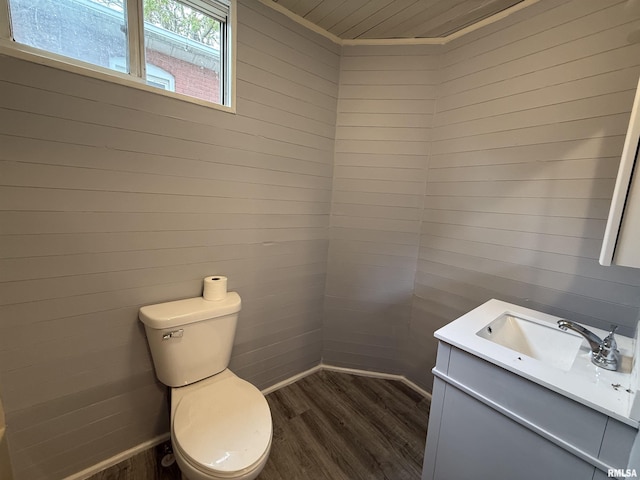 148 Robinson Ct, Canton, IL 61520 - half bath featuring wood finished floors, vanity, toilet, wood ceiling, and wood walls