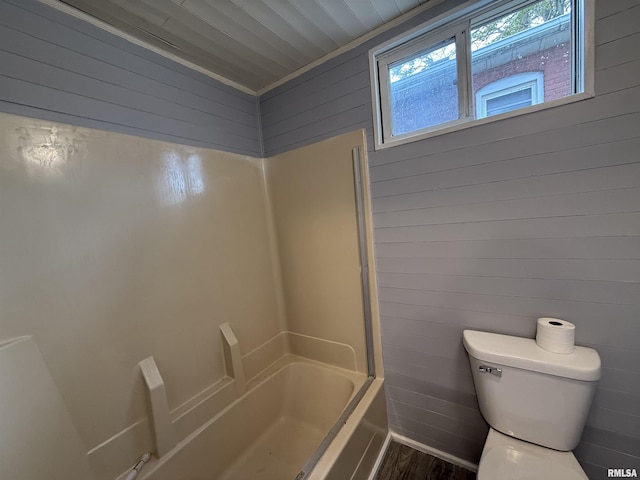 148 Robinson Ct, Canton, IL 61520 - full bath featuring toilet, wood finished floors, shower / bath combination, and wood walls