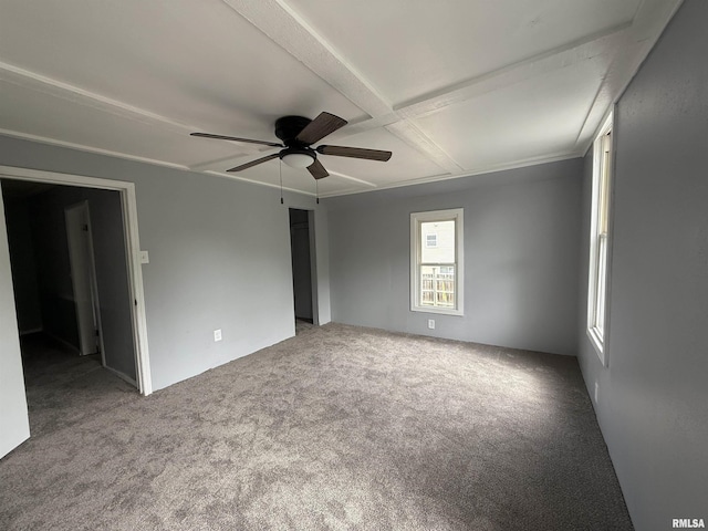carpeted spare room featuring ceiling fan, coffered ceiling, and beamed ceiling