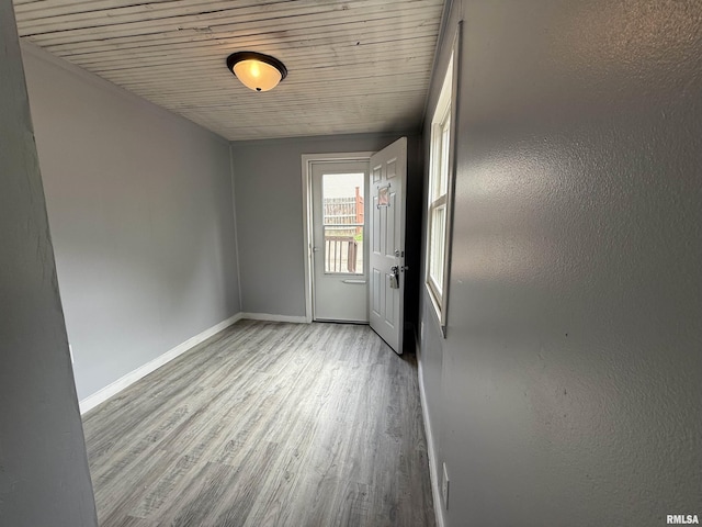 spare room featuring wood finished floors and baseboards