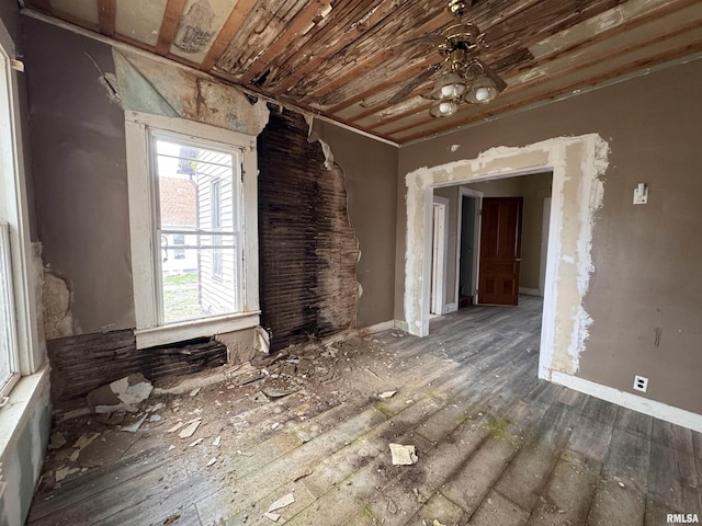 empty room featuring hardwood / wood-style flooring and baseboards