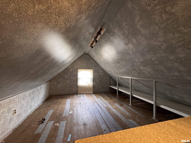 bonus room with vaulted ceiling and wood-type flooring
