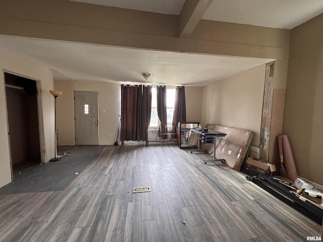 interior space with beamed ceiling and wood finished floors