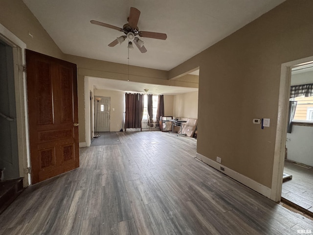 unfurnished living room with wood finished floors, baseboards, and ceiling fan