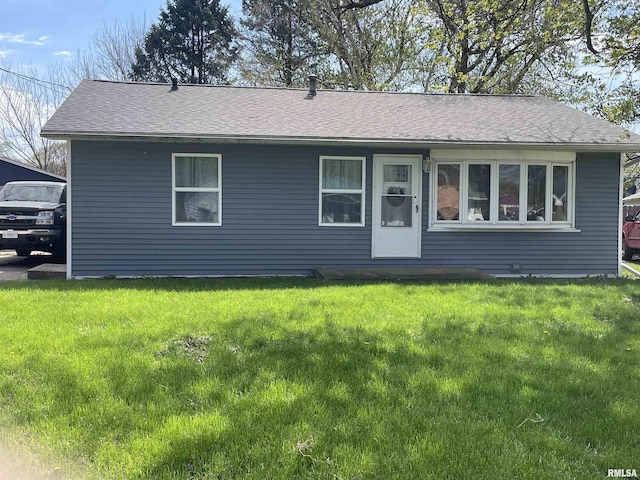 single story home with a shingled roof and a front lawn