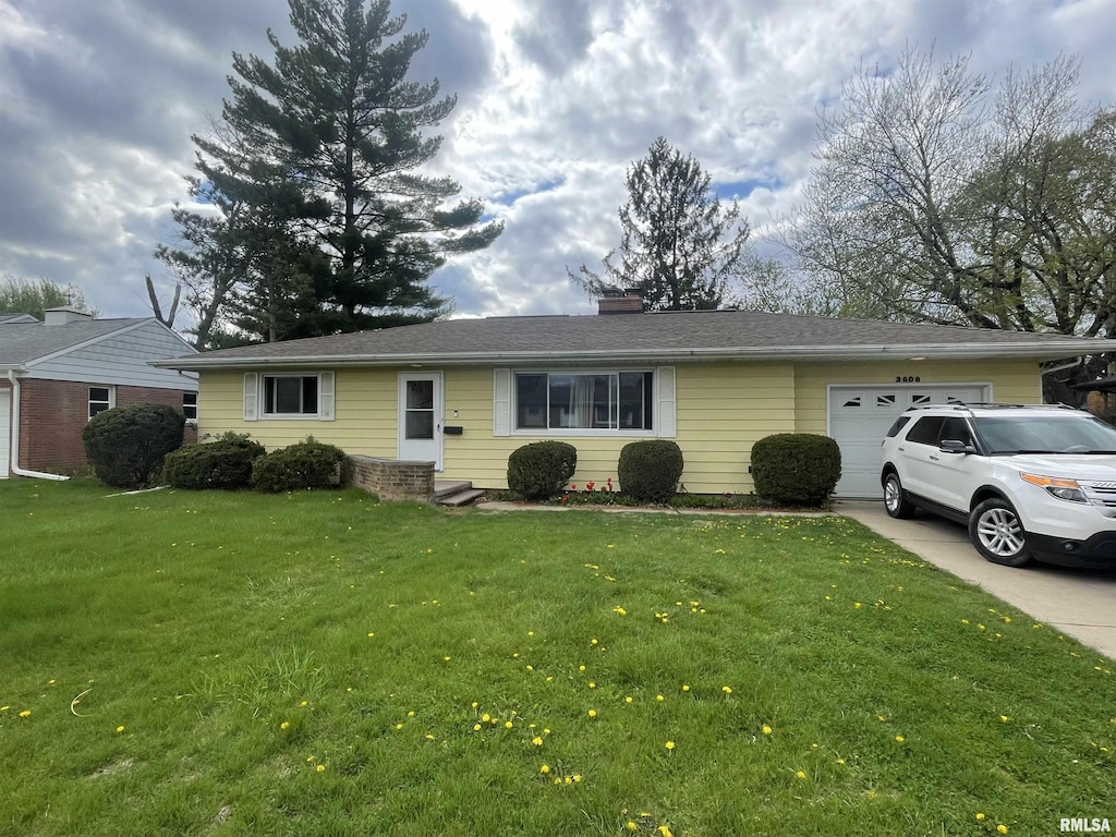 3609 N Rockwood Rd, Peoria, IL 61604 - ranch-style home with a garage, a chimney, a front lawn, and concrete driveway