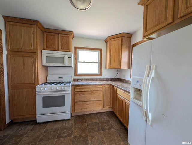 kitchen featuring stone finish floor and white appliances