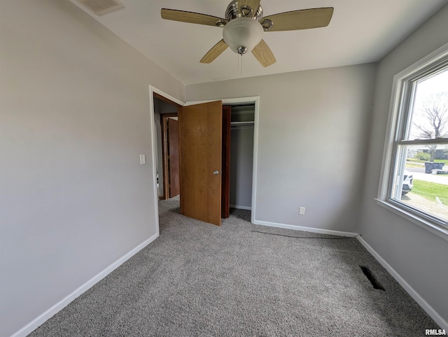 unfurnished bedroom featuring baseboards, visible vents, carpet, and a closet