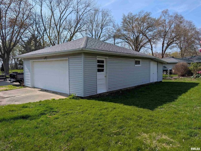 detached garage with concrete driveway