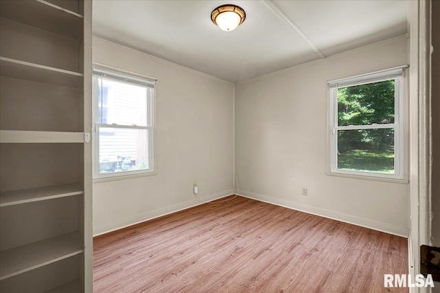 301 E Ellington Dr, Peoria, IL 61603 - empty room featuring plenty of natural light, wood finished floors, and crown molding