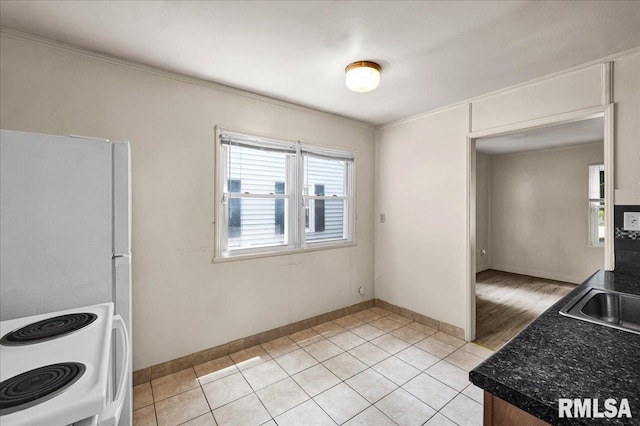 301 E Ellington Dr, Peoria, IL 61603 - kitchen featuring dark countertops, ornamental molding, light tile patterned floors, and white electric stove