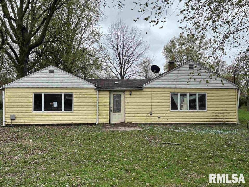 rear view of house with a yard