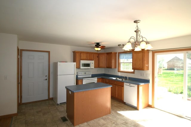 406 N Minier Ave, Minier, IL 61759 - kitchen featuring a center island, white appliances, dark countertops, and a sink