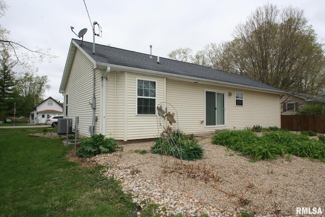 406 N Minier Ave, Minier, IL 61759 - back of property featuring a lawn, fence, and central AC unit