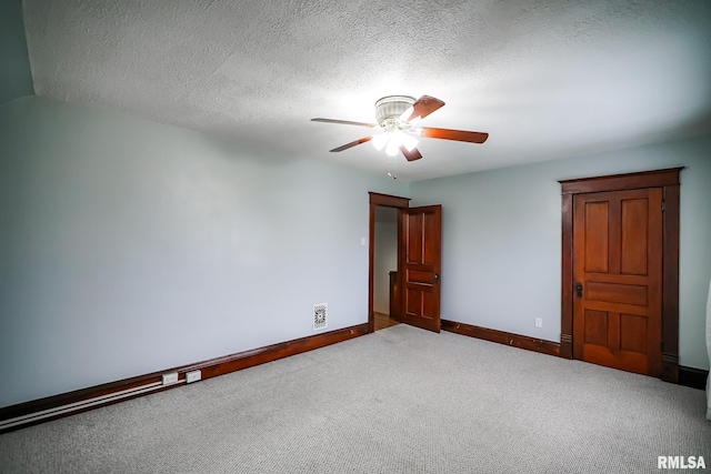 238 E Prospect St, Galesburg, IL 61401 - unfurnished room with a textured ceiling, ceiling fan, carpet floors, baseboards, and visible vents