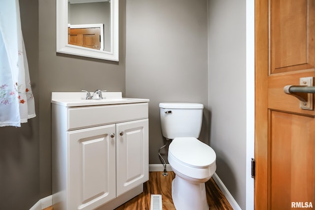 238 E Prospect St, Galesburg, IL 61401 - bathroom with toilet, visible vents, baseboards, wood finished floors, and vanity
