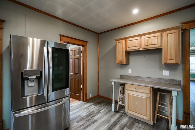 238 E Prospect St, Galesburg, IL 61401 - kitchen with baseboards, wood finished floors, built in study area, crown molding, and stainless steel fridge with ice dispenser