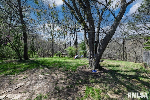 view of yard featuring fence and a view of trees