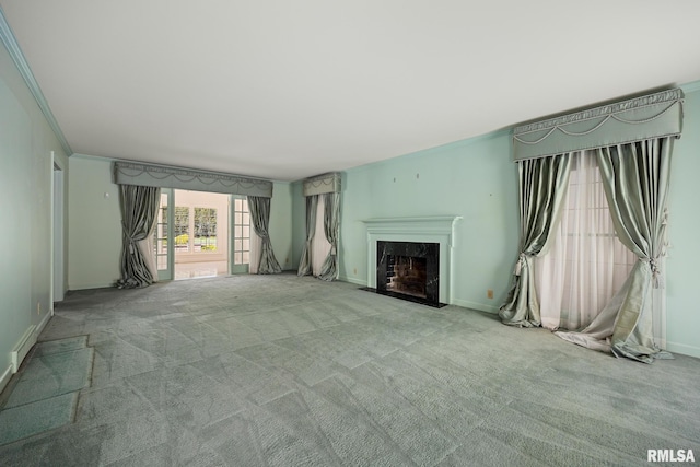 unfurnished living room featuring baseboards, carpet flooring, a fireplace, and ornamental molding