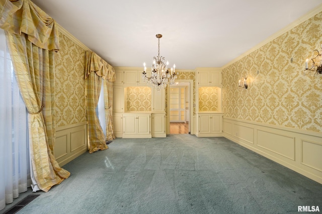 empty room with visible vents, an inviting chandelier, wallpapered walls, dark carpet, and a decorative wall