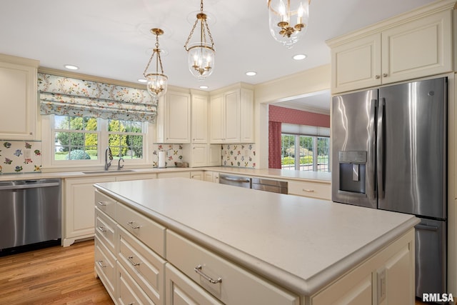 kitchen featuring a notable chandelier, cream cabinets, and appliances with stainless steel finishes
