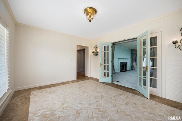 empty room featuring french doors, baseboards, carpet floors, and ornamental molding