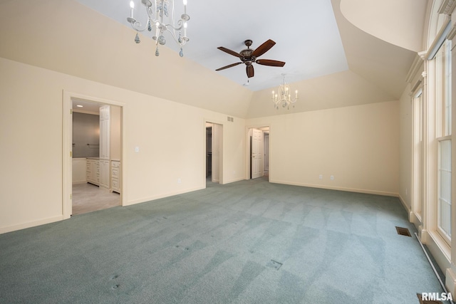 unfurnished bedroom with ensuite bath, light carpet, lofted ceiling, and visible vents