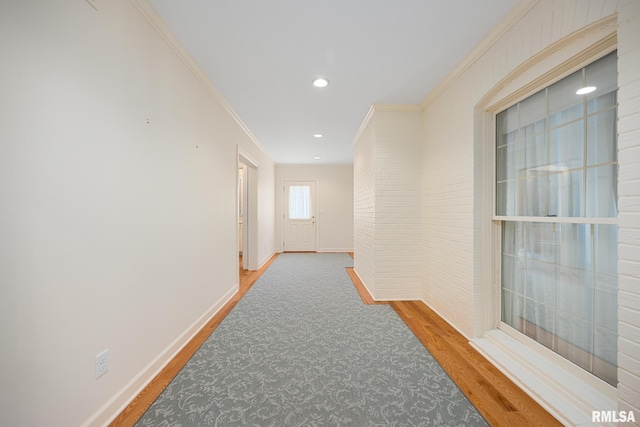 hallway with baseboards, ornamental molding, wood finished floors, and recessed lighting