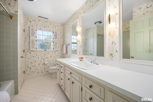full bathroom featuring wallpapered walls, vanity, walk in shower, toilet, and tile patterned flooring