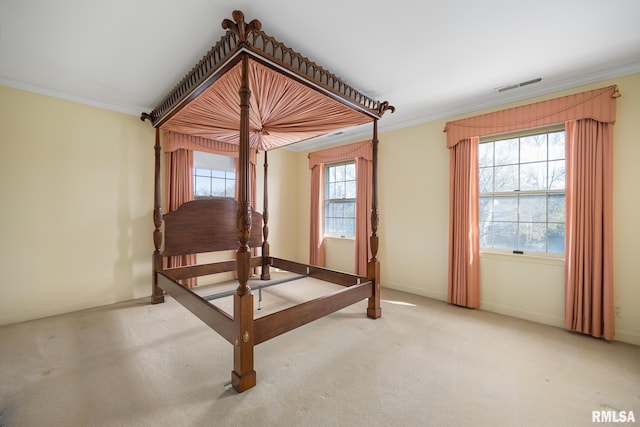 unfurnished bedroom with carpet floors, visible vents, crown molding, and baseboards