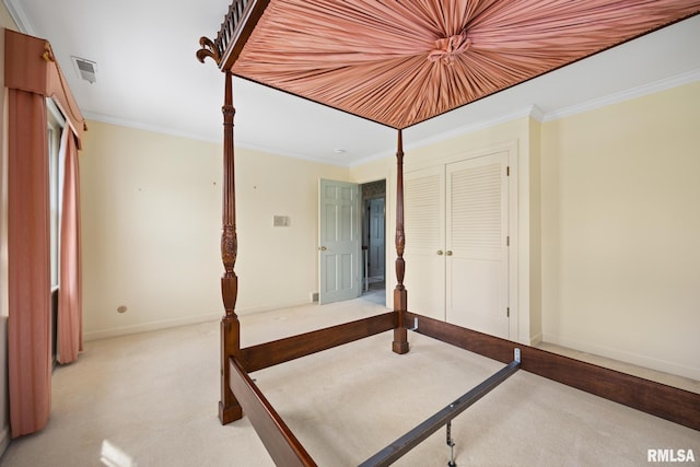 unfurnished bedroom with baseboards, crown molding, carpet flooring, and visible vents