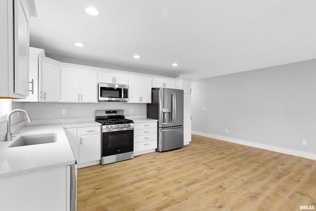 1109 Lawson St, Washington, IL 61571 - kitchen featuring appliances with stainless steel finishes, recessed lighting, white cabinets, and light wood-style flooring