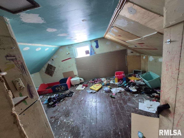 bonus room with wood-type flooring and vaulted ceiling
