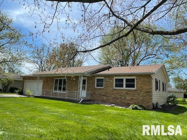 ranch-style house with a front yard, covered porch, brick siding, and a garage