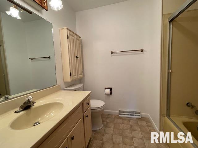 full bathroom featuring enclosed tub / shower combo, visible vents, toilet, vanity, and baseboards
