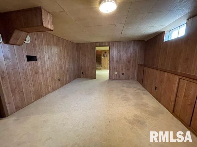basement featuring wooden walls