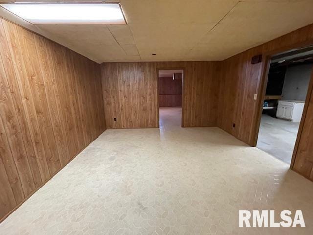 spare room featuring wood walls