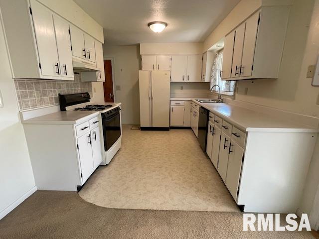 kitchen featuring range with gas cooktop, a sink, freestanding refrigerator, black dishwasher, and under cabinet range hood