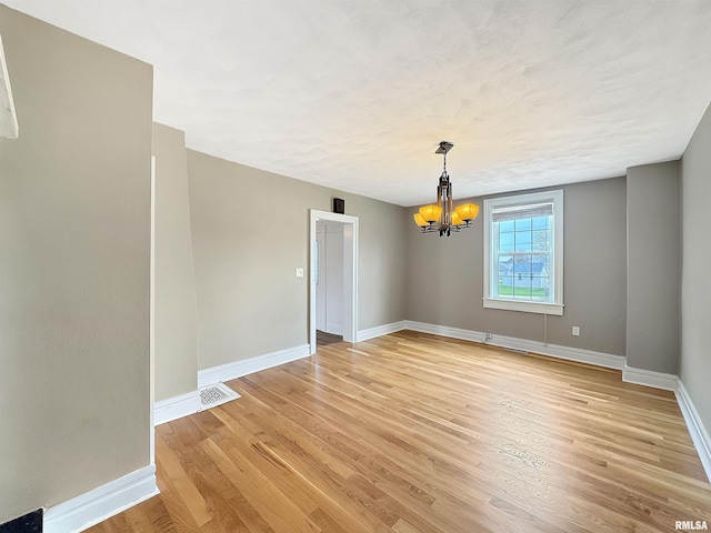 370 W Carter St, Fairview, IL 61432 - unfurnished room featuring an inviting chandelier, light wood-style floors, visible vents, and baseboards