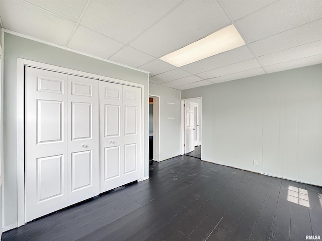 370 W Carter St, Fairview, IL 61432 - unfurnished bedroom with dark wood-style floors, a closet, and a drop ceiling