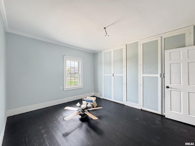 370 W Carter St, Fairview, IL 61432 - unfurnished bedroom with dark wood finished floors, baseboards, and ornamental molding