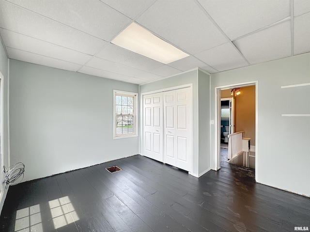 370 W Carter St, Fairview, IL 61432 - unfurnished bedroom featuring dark wood-style flooring, a drop ceiling, and a closet