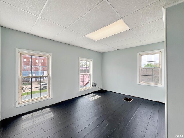 370 W Carter St, Fairview, IL 61432 - empty room featuring visible vents, a drop ceiling, and dark wood-style floors