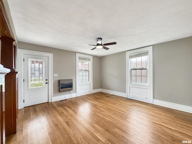 370 W Carter St, Fairview, IL 61432 - unfurnished living room featuring a fireplace, light wood-style floors, visible vents, and heating unit