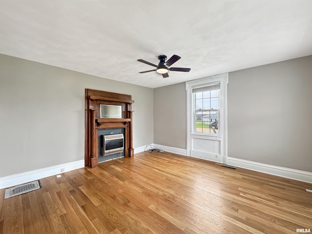 370 W Carter St, Fairview, IL 61432 - unfurnished living room with baseboards, visible vents, a ceiling fan, wood finished floors, and a fireplace
