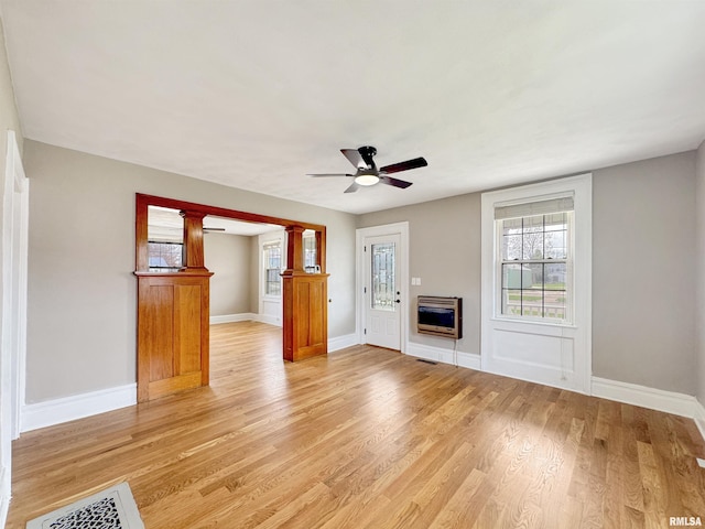 370 W Carter St, Fairview, IL 61432 - unfurnished living room with light wood-type flooring, baseboards, visible vents, heating unit, and ceiling fan