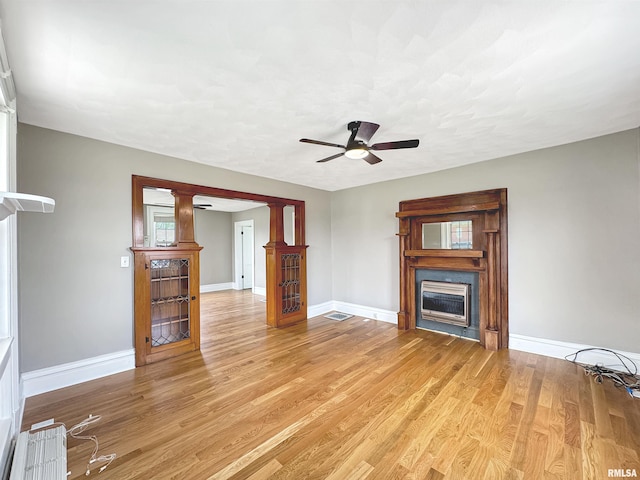 370 W Carter St, Fairview, IL 61432 - unfurnished living room with light wood-type flooring, a ceiling fan, baseboards, and a fireplace