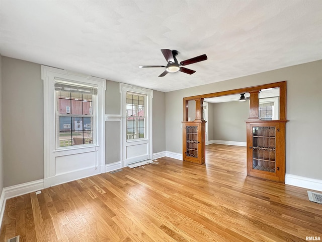 370 W Carter St, Fairview, IL 61432 - unfurnished living room featuring light wood-style floors, visible vents, baseboards, and ceiling fan